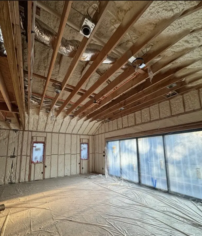 Interior walls and ceiling insulated with spray foam during new construction in Boonville